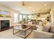 Cozy living room with a fireplace, plush sofa, and large windows at 18721 Dumbarton Oaks Dr, Cornelius, NC 28031