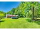 Large backyard features a pool, play area, and mature trees at 1938 Hickory Dr, Lancaster, SC 29720