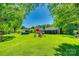Expansive backyard featuring lush greenery, an above-ground pool, and mature trees at 1938 Hickory Dr, Lancaster, SC 29720