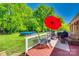 Outdoor deck with a red umbrella and backyard views at 1938 Hickory Dr, Lancaster, SC 29720