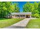 Charming home with a covered front porch and well-maintained lawn at 1938 Hickory Dr, Lancaster, SC 29720