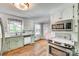 Bright kitchen features granite counters, white cabinets, and stainless steel appliances at 1938 Hickory Dr, Lancaster, SC 29720