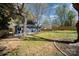 Backyard with patio, wooden fence, and newly seeded lawn at 2014 Sandhurst Dr, Charlotte, NC 28205