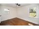 Bedroom with hardwood floors, fan, and natural light from windows at 2014 Sandhurst Dr, Charlotte, NC 28205