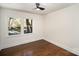 Bedroom with wood floors, a window view of the outside, and a ceiling fan at 2014 Sandhurst Dr, Charlotte, NC 28205