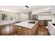 Modern kitchen with stainless steel appliances, island cooktop, and sleek white cabinetry at 2014 Sandhurst Dr, Charlotte, NC 28205
