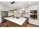 Modern kitchen with stainless steel appliances, island cooktop, and sleek white cabinetry at 2014 Sandhurst Dr, Charlotte, NC 28205