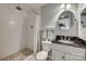 This bathroom features a walk-in shower with white tile, a pebble floor, and a black granite vanity countertop at 2058 Manila Bay Ln, Fort Mill, SC 29708