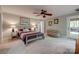 Comfortable bedroom with soft carpet, a ceiling fan, and access to an outdoor area at 2058 Manila Bay Ln, Fort Mill, SC 29708