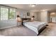 A carpeted bedroom is furnished with a queen bed between two end tables and has a bright window at 2058 Manila Bay Ln, Fort Mill, SC 29708