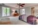 Spacious bedroom with a large window, modern ceiling fan, and a sliding barn door to the bathroom at 2058 Manila Bay Ln, Fort Mill, SC 29708