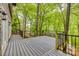 A spacious deck is surrounded by lush greenery and trees, perfect for outdoor entertaining and overlooking the area at 2058 Manila Bay Ln, Fort Mill, SC 29708