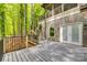 A spacious deck is surrounded by lush greenery and trees, and provides access to a covered area at 2058 Manila Bay Ln, Fort Mill, SC 29708