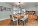 Inviting dining room featuring hardwood floors, a modern chandelier, and access to the living spaces at 2058 Manila Bay Ln, Fort Mill, SC 29708