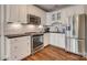 Modern kitchen with stainless steel appliances, white cabinets, and backsplash at 2058 Manila Bay Ln, Fort Mill, SC 29708