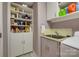 Laundry room featuring storage shelves, cabinets, sink, and appliances at 2058 Manila Bay Ln, Fort Mill, SC 29708