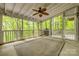 Spacious screened porch with a ceiling fan, string lights, and views of the surrounding trees at 2058 Manila Bay Ln, Fort Mill, SC 29708