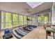 Bright sunroom featuring a tile floor, workout equipment, and large windows showcasing the natural surroundings at 2058 Manila Bay Ln, Fort Mill, SC 29708