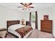 Neutral bedroom features a ceiling fan, natural light, dresser, and carpeted floor at 2315 Collins Dr, Albemarle, NC 28001