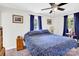 A bedroom filled with natural light with a double bed, ceiling fan, and wooden drawers at 2315 Collins Dr, Albemarle, NC 28001