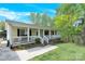 Beautiful home with a welcoming front porch, lush landscaping, and walkway at 2315 Collins Dr, Albemarle, NC 28001