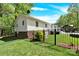 Exterior of home and yard with a black fence around it showing an open outdoor space at 2315 Collins Dr, Albemarle, NC 28001