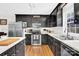 Sleek kitchen featuring black cabinetry, stainless steel appliances, and hardwood floors at 2315 Collins Dr, Albemarle, NC 28001