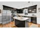 Well-lit kitchen boasts stainless steel appliances, dark wood cabinets, and center island at 2315 Collins Dr, Albemarle, NC 28001
