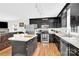 Modern kitchen with black cabinets, stainless steel appliances, and central island at 2315 Collins Dr, Albemarle, NC 28001