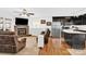 Open-concept living area includes a stone fireplace and view into the stainless steel kitchen at 2315 Collins Dr, Albemarle, NC 28001