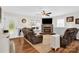 Inviting living room features a stone fireplace, large windows, and cozy leather furniture at 2315 Collins Dr, Albemarle, NC 28001