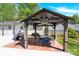 Outdoor dining and entertaining under a covered patio, complete with furniture and grill at 2315 Collins Dr, Albemarle, NC 28001