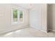 Bright bedroom featuring neutral carpet, a window, and a double-door closet at 2615 Toddville Rd, Charlotte, NC 28214