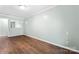 Bright bedroom with wood-look flooring and a mirror accent wall at 2615 Toddville Rd, Charlotte, NC 28214