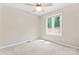 Cozy bedroom with neutral carpet, ceiling fan, and a window providing natural light at 2615 Toddville Rd, Charlotte, NC 28214