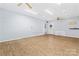Spacious bonus room with wood-look flooring, ceiling fans, and ample lighting at 2615 Toddville Rd, Charlotte, NC 28214