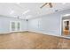 Large bonus room with wood-look flooring, ceiling fans, and access to other rooms at 2615 Toddville Rd, Charlotte, NC 28214