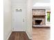 Inviting entryway featuring a stylish front door, hardwood flooring, and fireplace at 2615 Toddville Rd, Charlotte, NC 28214