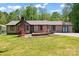 Charming one-story home featuring a brick chimney, well-manicured lawn, and inviting curb appeal at 2615 Toddville Rd, Charlotte, NC 28214