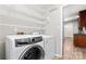 Modern laundry room features an Electrolux washer/dryer set and white wire shelving at 2615 Toddville Rd, Charlotte, NC 28214