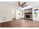 Spacious living room with hardwood flooring, fan, and brick fireplace at 2615 Toddville Rd, Charlotte, NC 28214