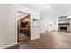 Charming living room featuring hardwood floors, a brick fireplace, and views of the connected kitchen at 2615 Toddville Rd, Charlotte, NC 28214