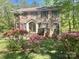 Charming two-story brick home with a well-maintained lawn and beautiful flowering bushes at 3063 Wimbledon Ln, Rock Hill, SC 29732
