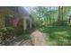 Charming brick home with mature trees, manicured lawn, and an American flag proudly displayed at 3063 Wimbledon Ln, Rock Hill, SC 29732