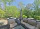 Secluded back patio with outdoor seating surrounded by lush trees at 3063 Wimbledon Ln, Rock Hill, SC 29732
