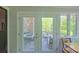 French doors open to an outdoor patio, with seating and a lush, green backyard at 3063 Wimbledon Ln, Rock Hill, SC 29732
