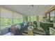 Bright sunroom with large windows offering scenic views, a comfortable seating area, and a relaxing atmosphere at 3063 Wimbledon Ln, Rock Hill, SC 29732