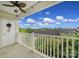 Balcony area featuring a ceiling fan, white railing, and a treeline view at 314 Wave Crest Dr, Tega Cay, SC 29708