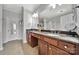 Elegant bathroom with dual sinks, granite countertops, and a large mirror at 314 Wave Crest Dr, Tega Cay, SC 29708