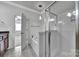 Bathroom featuring a glass shower, soaking tub, and access to the bedroom at 314 Wave Crest Dr, Tega Cay, SC 29708